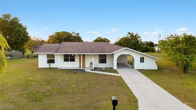 ranch-style home featuring a carport and a front yard