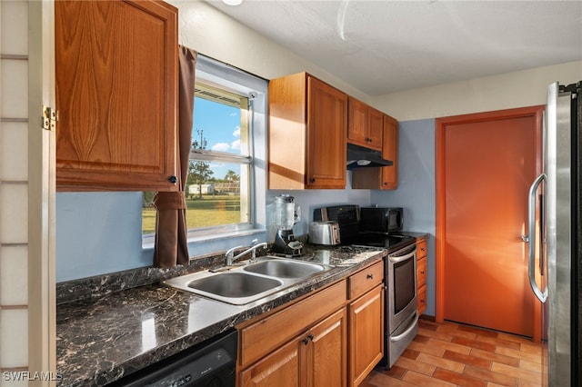 kitchen with sink, dark stone counters, and black appliances