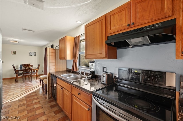 kitchen featuring electric stove, black dishwasher, sink, and a textured ceiling