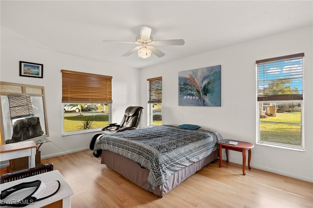 bedroom with ceiling fan and light hardwood / wood-style flooring