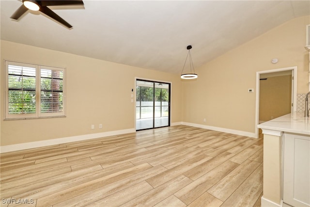 interior space featuring ceiling fan, light hardwood / wood-style floors, and vaulted ceiling