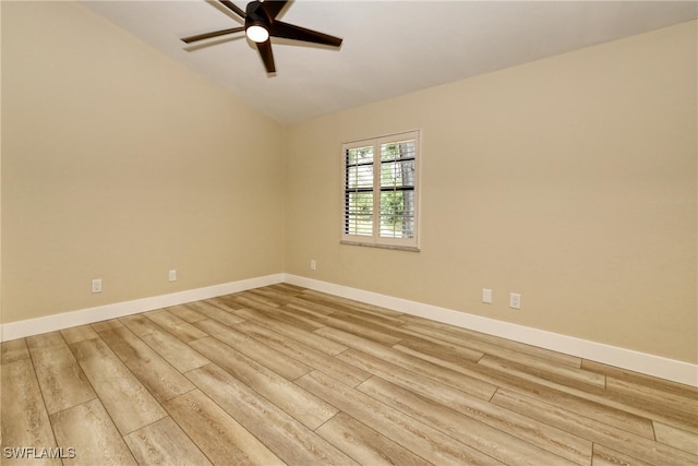 empty room with vaulted ceiling, ceiling fan, and light wood-type flooring