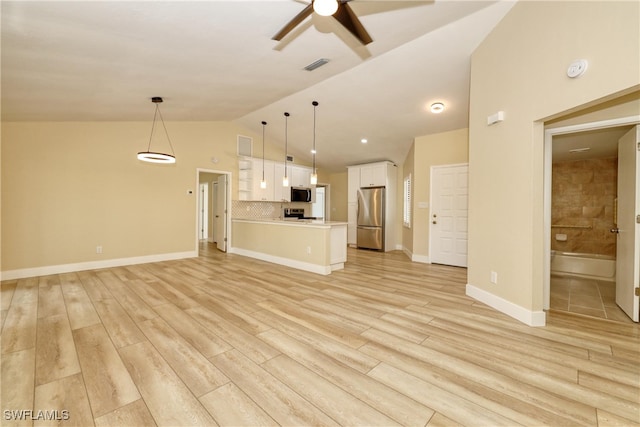 unfurnished living room featuring ceiling fan, vaulted ceiling, and light hardwood / wood-style floors