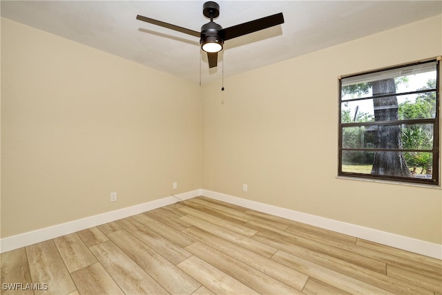 spare room with ceiling fan and light wood-type flooring