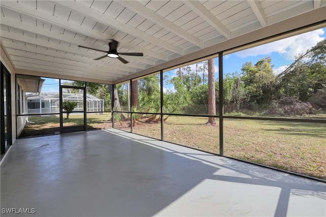 unfurnished sunroom featuring beam ceiling