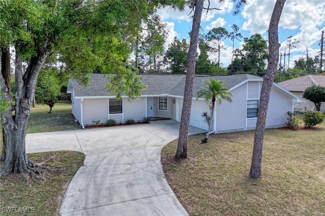 ranch-style home featuring a garage and a front lawn