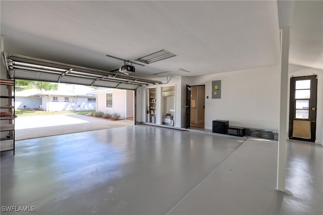 garage with a garage door opener and electric panel