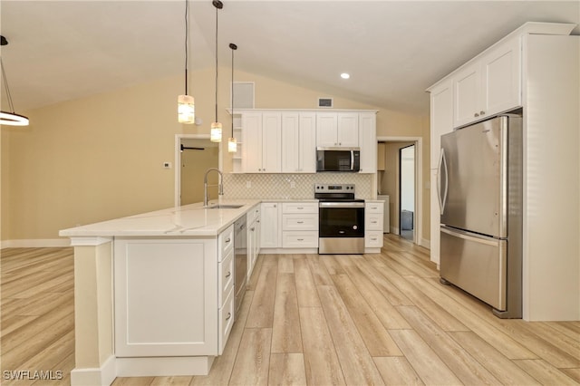 kitchen featuring sink, white cabinetry, kitchen peninsula, pendant lighting, and stainless steel appliances