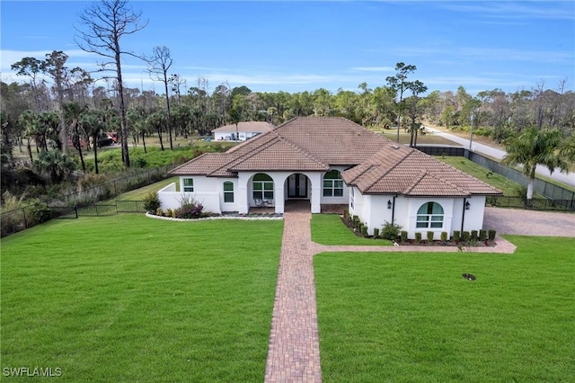 mediterranean / spanish home featuring a front lawn