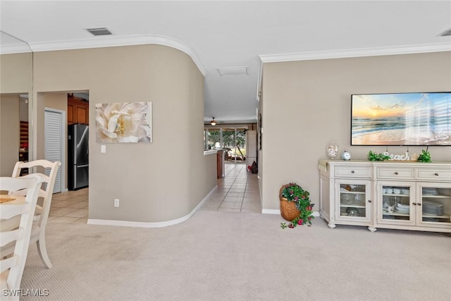 corridor featuring crown molding, baseboards, visible vents, and light colored carpet