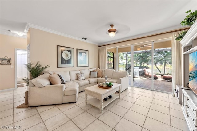 living room featuring visible vents, crown molding, and light tile patterned flooring