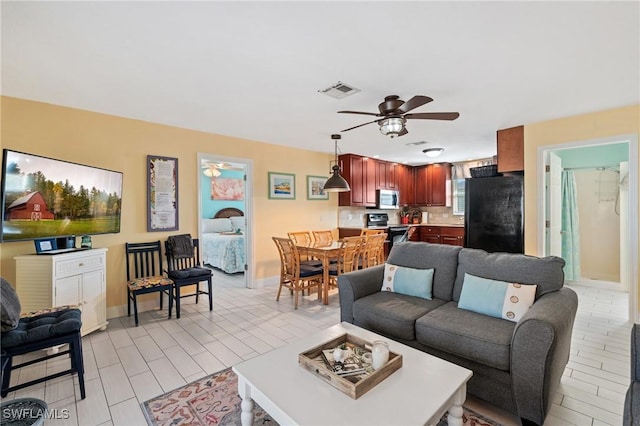 living room featuring ceiling fan and light wood-type flooring