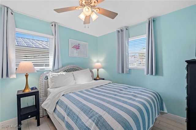 bedroom with light hardwood / wood-style floors and ceiling fan