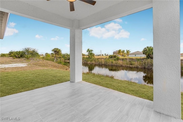 view of patio / terrace with a water view and a ceiling fan