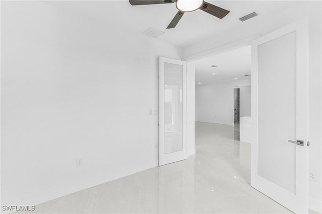 unfurnished room featuring visible vents and a ceiling fan