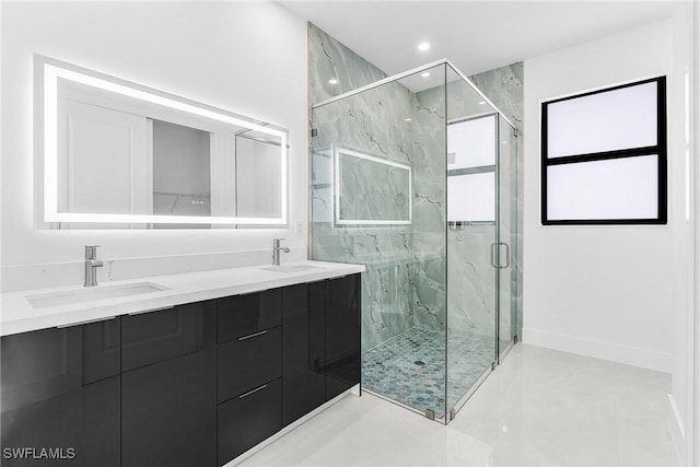 full bath with double vanity, a sink, a marble finish shower, and recessed lighting