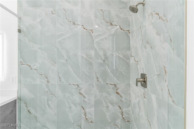 bathroom with a marble finish shower