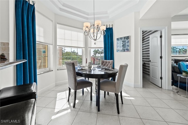 dining area with a notable chandelier, crown molding, light tile patterned floors, a raised ceiling, and baseboards