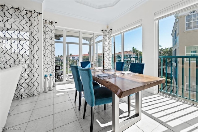 dining area featuring ornamental molding and tile patterned floors