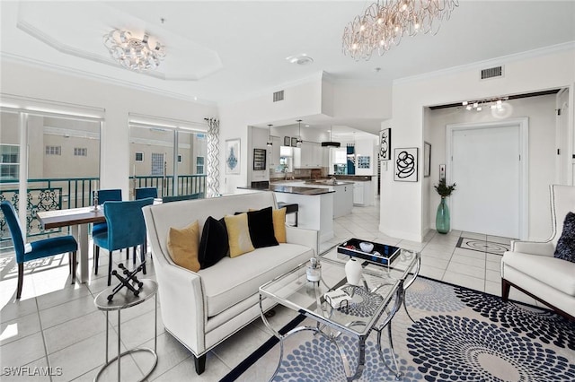 living room featuring an inviting chandelier, visible vents, light tile patterned floors, and ornamental molding