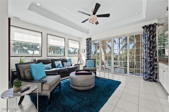 sunroom / solarium featuring ceiling fan and a raised ceiling