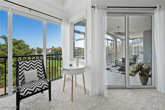 sunroom with a healthy amount of sunlight and ceiling fan