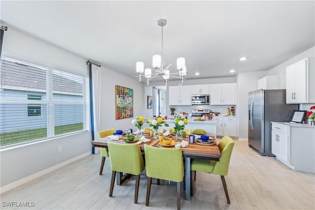 dining area with recessed lighting, light wood-type flooring, an inviting chandelier, and baseboards