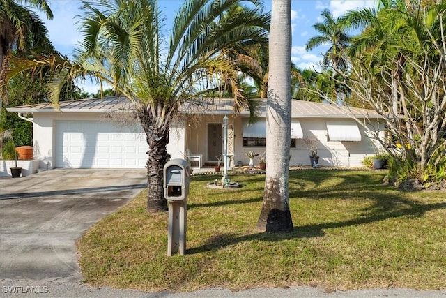 single story home featuring a garage and a front yard