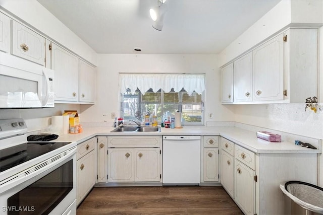 kitchen featuring dark hardwood / wood-style flooring, sink, white cabinets, and white appliances