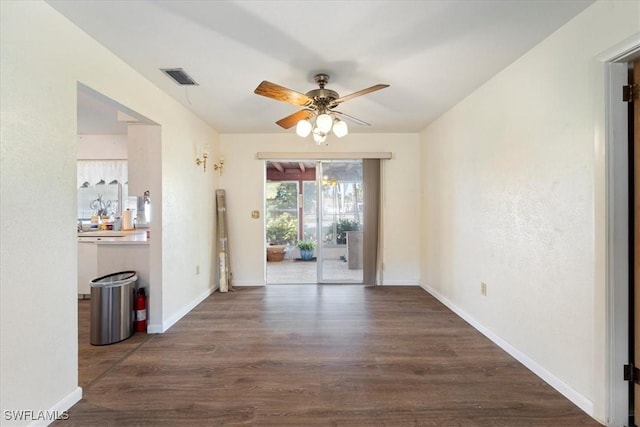 interior space featuring dark wood-type flooring and ceiling fan