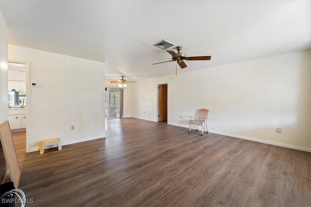 unfurnished living room with dark hardwood / wood-style flooring and ceiling fan