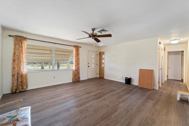 unfurnished living room featuring ceiling fan and dark hardwood / wood-style flooring