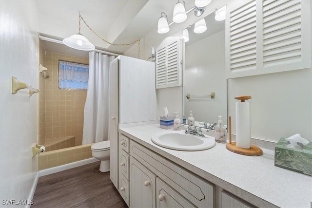 full bathroom featuring vanity, hardwood / wood-style floors, shower / bathtub combination with curtain, and toilet