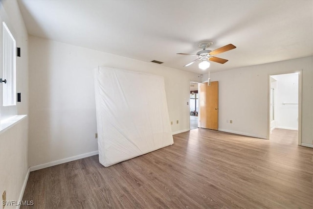 empty room featuring ceiling fan and hardwood / wood-style floors