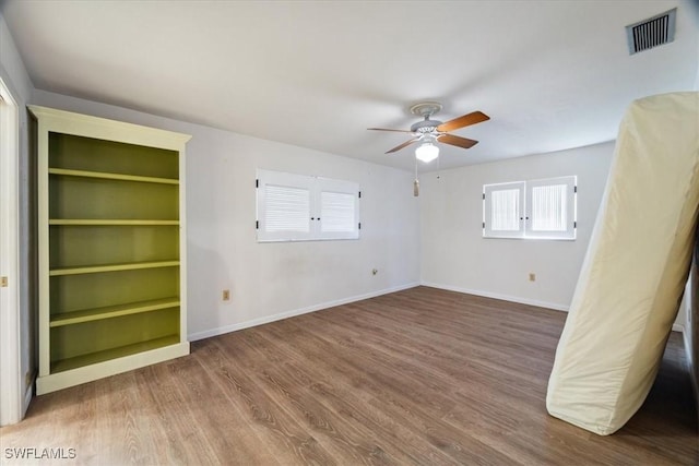 unfurnished bedroom with hardwood / wood-style floors and ceiling fan