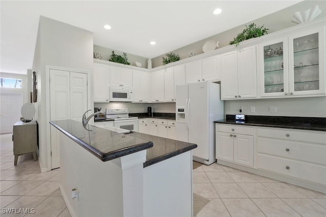 1118 Dorchester Ct, Naples, FL 34104 - kitchen featuring white cabinetry, light tile patterned floors, and white appliances