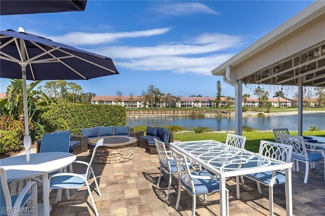 1118 Dorchester Ct, Naples, FL 34104 - view of patio / terrace with a water view, outdoor dining space, and an outdoor living space with a fire pit