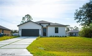 view of front of property with a garage and a front yard