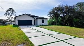 ranch-style home featuring a garage and a front lawn