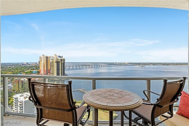 balcony with a water view and a city view