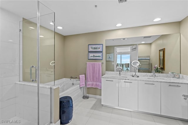 bathroom with a garden tub, double vanity, recessed lighting, a stall shower, and a sink