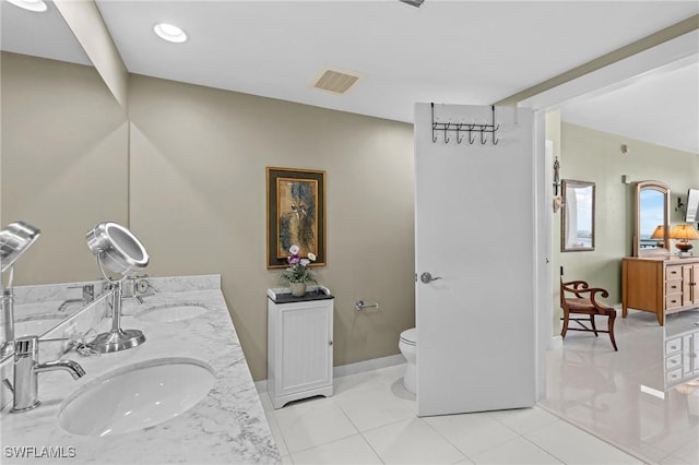 full bath featuring double vanity, visible vents, toilet, and a sink