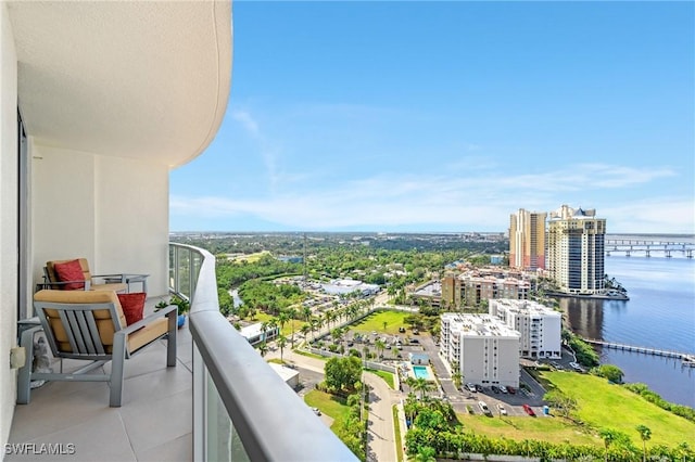 balcony featuring a view of city and a water view