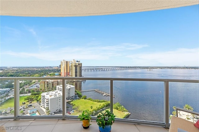 balcony with a water view and a city view