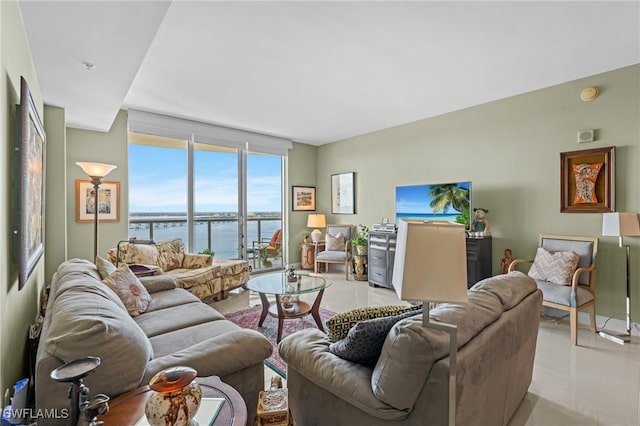 living area featuring expansive windows and light tile patterned floors