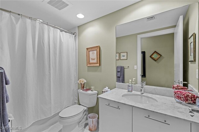 full bath with toilet, vanity, and visible vents