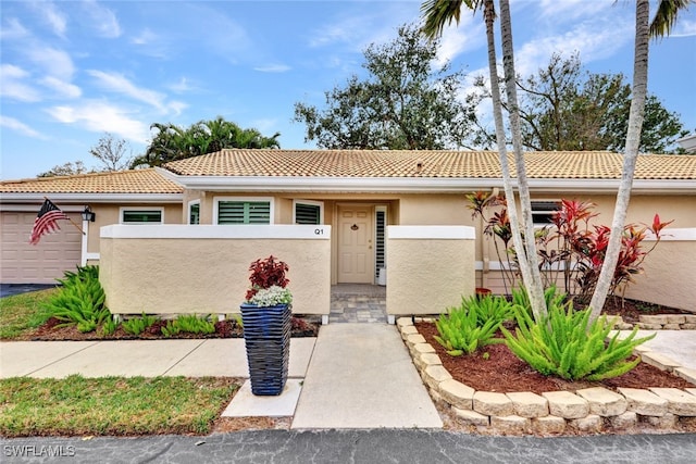 single story home with a fenced front yard, a tile roof, and stucco siding