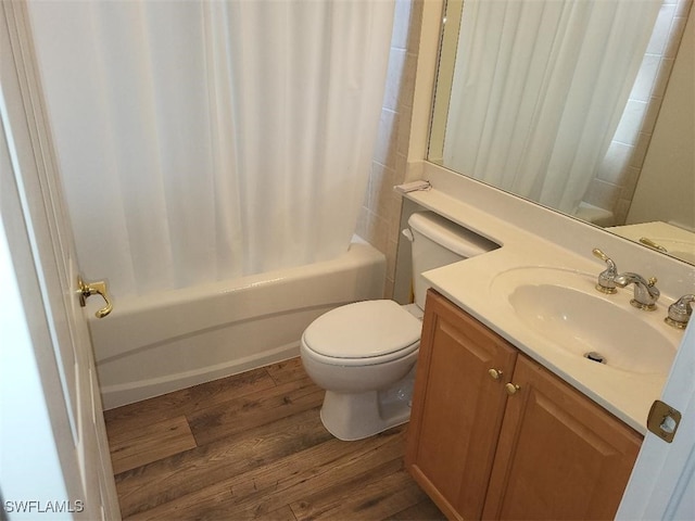 full bathroom with vanity, hardwood / wood-style floors, shower / bath combo, and toilet