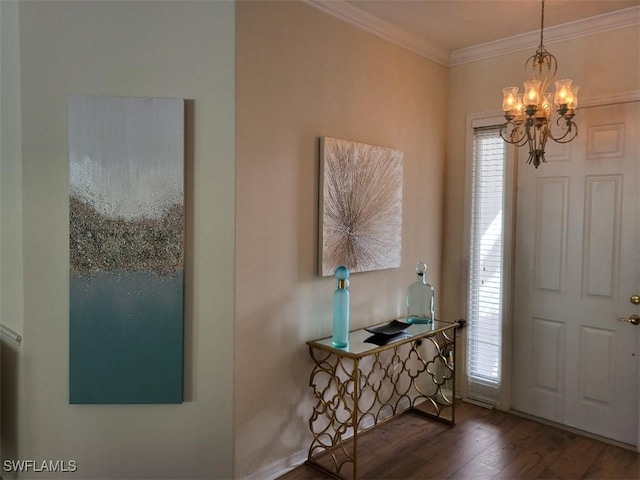 foyer entrance featuring crown molding, dark hardwood / wood-style floors, and an inviting chandelier