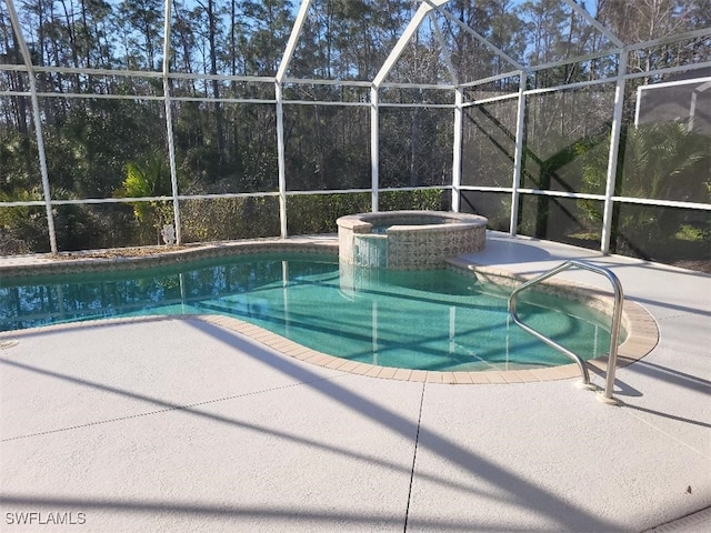 view of swimming pool featuring an in ground hot tub, a lanai, and a patio area